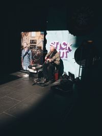 People sitting in illuminated room