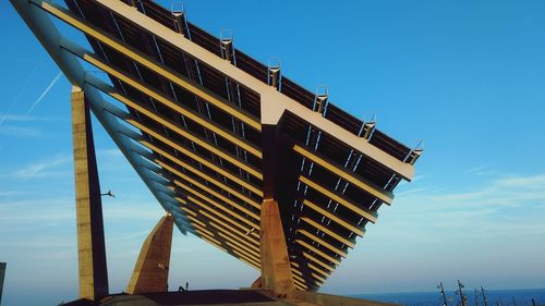 Low angle view of solar panels against blue sky