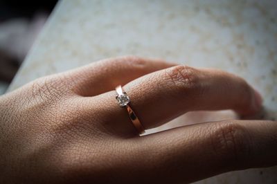 Cropped image of woman wearing diamond ring