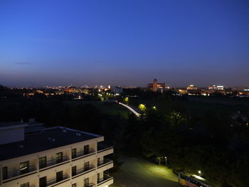 High angle view of illuminated buildings against clear sky at night