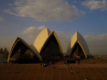 View of modern building against cloudy sky