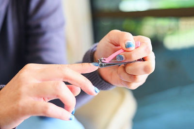 Cropped hand of woman holding dental equipment