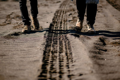 Low section of people walking on road