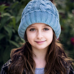 Portrait of cute smiling girl standing outdoors