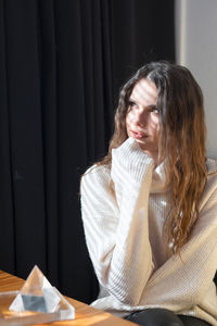 Portrait of woman sitting on table