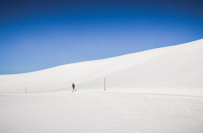 Scenic view of snowcapped mountains against clear blue sky