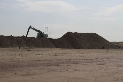 Bulldozer at construction site against sky