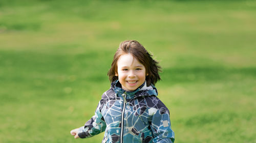 Portrait of smiling girl on field