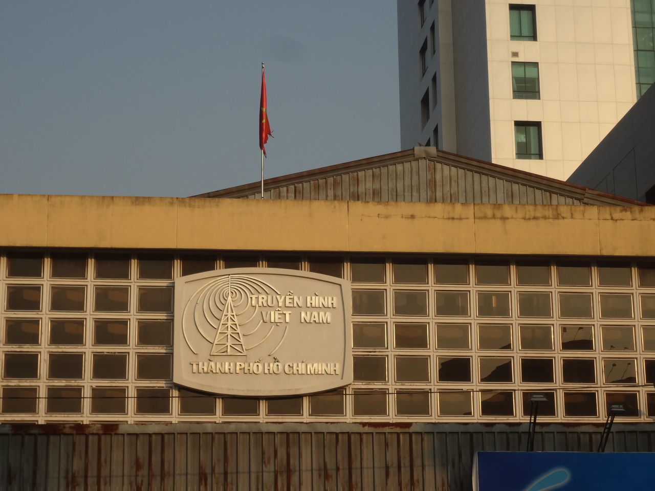 CLOSE-UP OF FLAGS AGAINST BUILDING