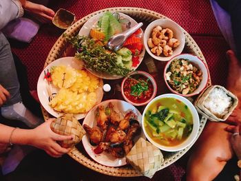 Cropped image of people having food at table