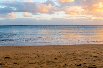 Scenic view of beach against sky during sunset