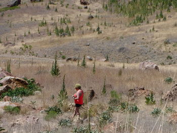Rear view of woman walking on field