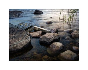 Close-up of rocks on beach against sky