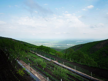 High angle view of land and sea against sky