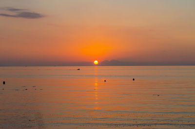 Scenic view of sea against romantic sky at sunset