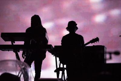 Silhouette people standing on stage