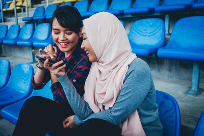 Woman sitting on mobile phone