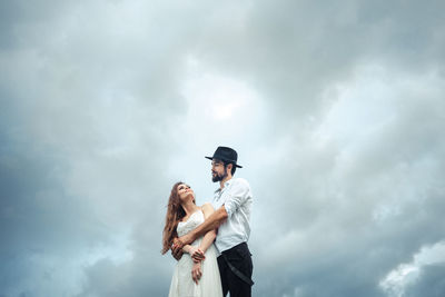 Low angle view of man standing against sky