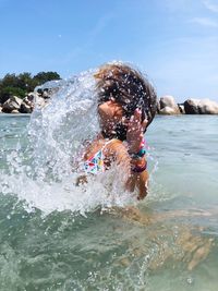 Girl splashing water with hair
