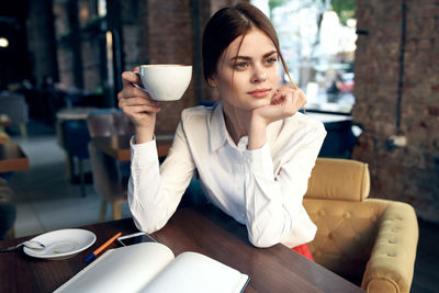 Young woman drinking coffee cup