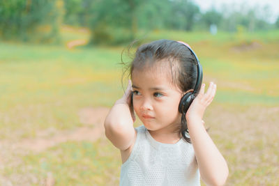 Portrait of cute girl standing on field