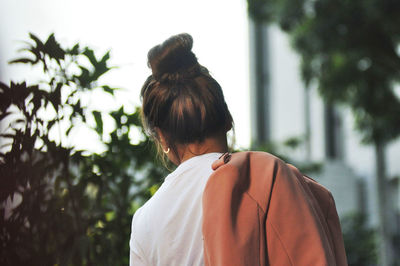 Rear view of woman looking at tree