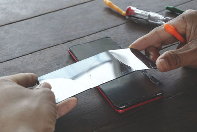 High angle view of person hand on table