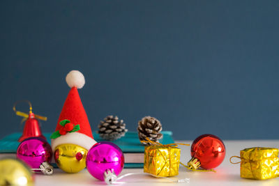 Close-up of toys on table against colored background