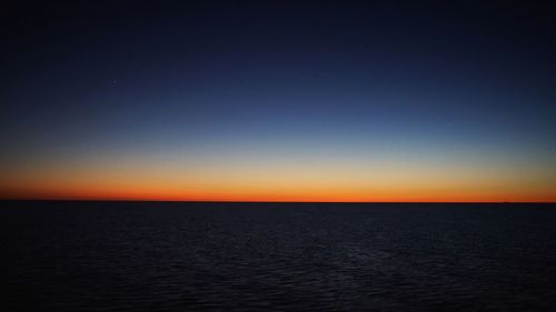 Scenic view of sea against clear sky during sunset