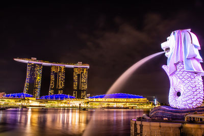 Illuminated building against sky at night