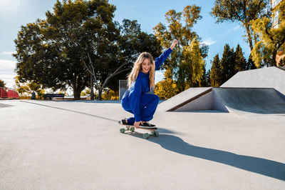 Smiling woman skating at park