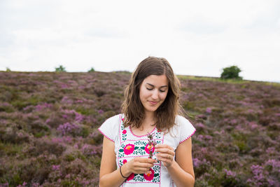 Young woman standing on field