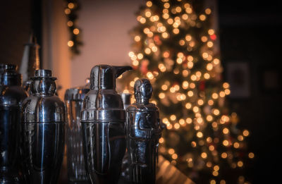 Figurines on table against illuminated lights