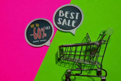 Close-up of information sign on pink board