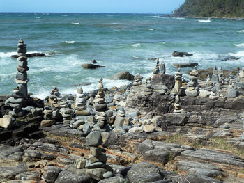 Rocks on beach against sky