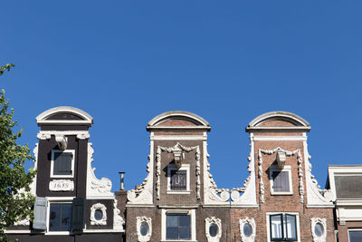 Low angle view of building against clear blue sky