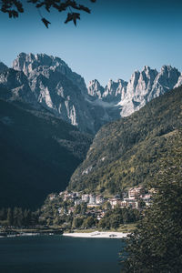 Scenic view of sea and mountains against clear sky