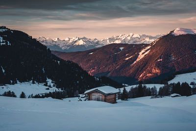 Scenic view of snowcapped mountains against sky during sunset