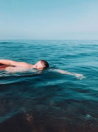 Portrait of boy swimming in sea