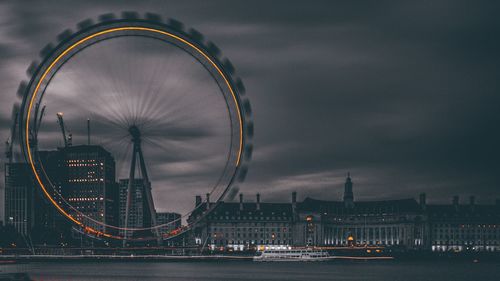 Millennium wheel in city at night