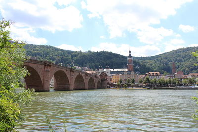 View of bridge over river against cloudy sky