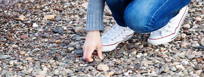 Low section of woman standing on ground