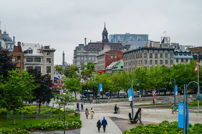 People walking in park against sky