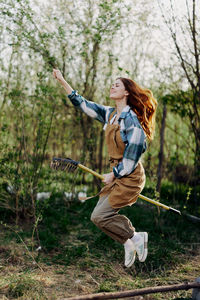 Rear view of woman standing on field