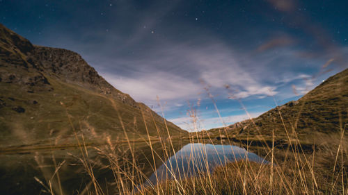 Scenic view of snowcapped mountains against sky at night