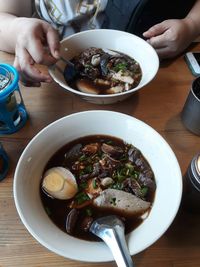 Midsection of person having food on table