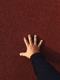 Cropped hand of man touching wall