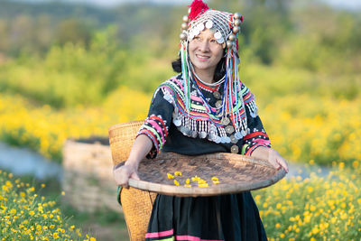 Woman holding a smiling while standing on field