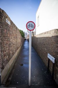 Low angle view of road sign against sky