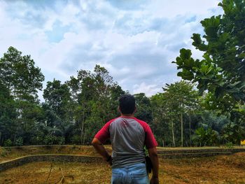 Rear view of man standing against sky